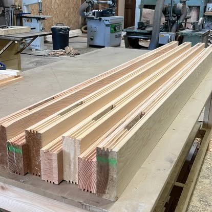 Carefully machined timber components prepared on a workshop bench
